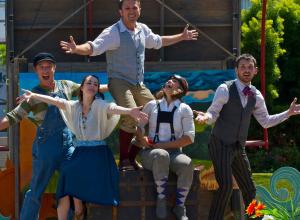 Idiot String, group of five performers outside with arms extended