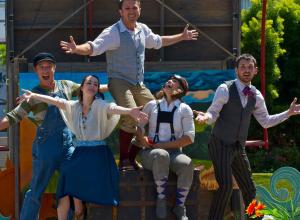 Idiot String, group of five performers outside with arms extended